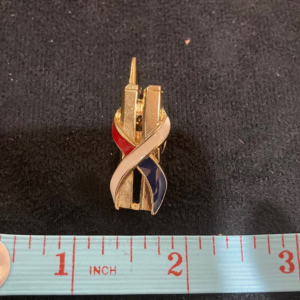 Red white and blue ribbon over twin towers pin